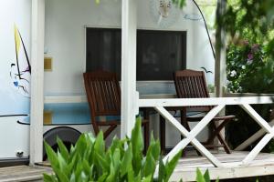 two chairs and a table on a porch at S3 Seahorse Beach Club in Oludeniz