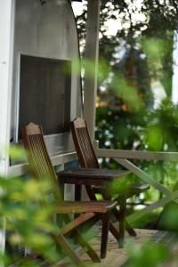 two wooden chairs sitting on a porch with a mirror at S3 Seahorse Beach Club in Oludeniz