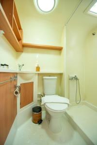 a bathroom with a white toilet and a shower at S3 Seahorse Beach Club in Oludeniz