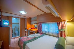 a small room with a bed and a window at S3 Seahorse Beach Club in Oludeniz