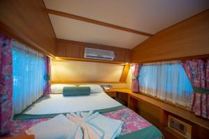 a small bedroom with a bed in a boat at S3 Seahorse Beach Club in Oludeniz