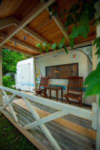 a deck with two chairs and a table and a trailer at S3 Seahorse Beach Club in Oludeniz