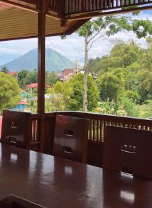 a room with a table and a view of a mountain at A beautiful and Spacious Rumah Manado 2 Bedrooms with Bathrooms Villa Marion Tomohon in Tomohon