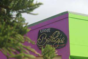 a purple and green building with a sign on it at Lodge Bellagio in Mthatha