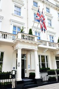 a large building with a flag on top of it at Eccleston Square Hotel in London