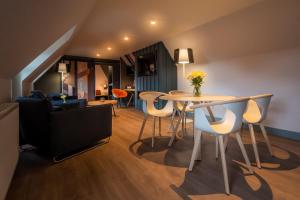 a living room with a table and chairs and a couch at Sligachan Hotel in Sconser