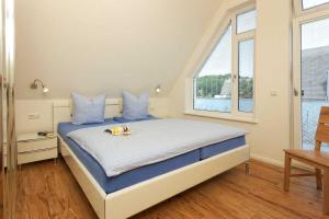 a bedroom with a bed with a dog on it at Kapitaensweg 32 in Ostseebad Karlshagen