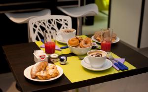 a table with plates of food and cups of coffee and pastries at Sorrento Flats in Sorrento