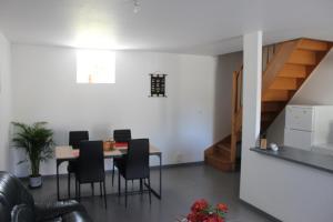 une salle à manger avec une table et des chaises et un escalier dans l'établissement Chez Marie et christian, à La Boussac 9 autres photos