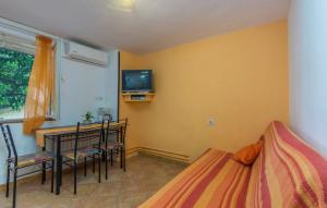 a bedroom with a bed and a table and a tv at Apartment Complex Sauko in Poreč