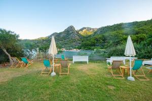 a group of chairs and tables and umbrellas at S3 Seahorse Beach Club in Oludeniz