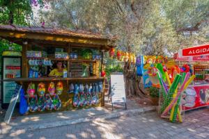 a store with a woman standing in front of it at S3 Seahorse Beach Club in Oludeniz