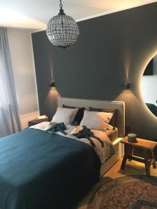 a bedroom with a bed and a chandelier at Cityapartment Graz in Graz