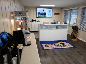 an office with a counter and a refrigerator at Early American Motel in Aurora