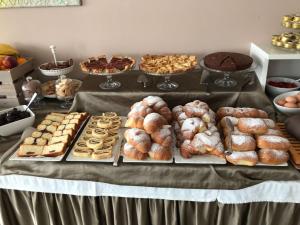 a table filled with different types of pastries and cakes at Bikini Hotel in Vieste