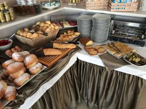 a table filled with different types of bread and pastries at Bikini Hotel in Vieste