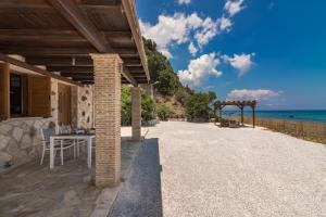 a patio with a table and a view of the ocean at Villa Julia in Zakynthos Town