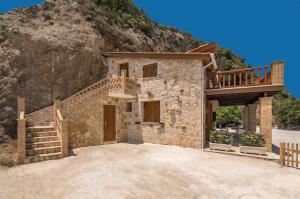 a stone house with a staircase and a balcony at Villa Julia in Zakynthos Town