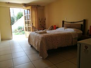 Postel nebo postele na pokoji v ubytování Las Cumbres INN
