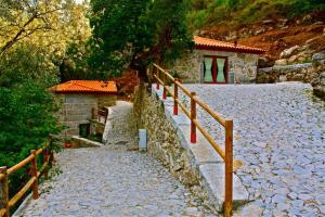 a stone path with a fence next to a building at Aldeia Do Pontido in Fafe