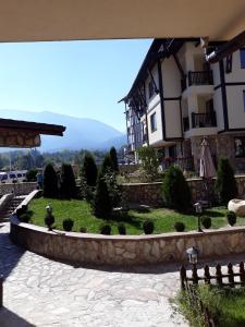 a house with a garden in front of it at Mountain Top Mina in Bansko