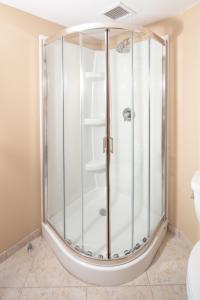 a glass shower in a bathroom with a toilet at Red Lion Hotel Orlando Lake Buena Vista South- Near Disney in Kissimmee