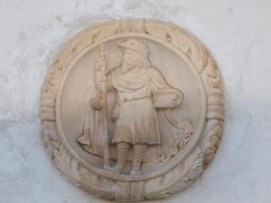 a stone sculpture of a man holding at Domus Viatoris in Sahagún