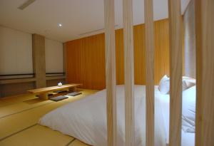 Postel nebo postele na pokoji v ubytování 小小邸 Small Hotel