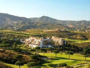 a view of a resort with mountains in the background at La Cala Resort in La Cala de Mijas