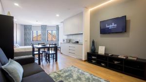 a living room with a couch and a dining room at Bugalha My Loft Douro 4 in Peso da Régua