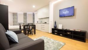a living room with a couch and a dining room at Bugalha My Loft Douro 4 in Peso da Régua +10 photos