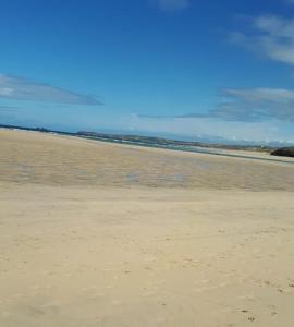 an empty beach with the ocean in the background at 11 longstone house in Carbis Bay