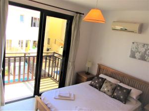 a bedroom with a bed and a balcony at Villa Jade in Paralimni
