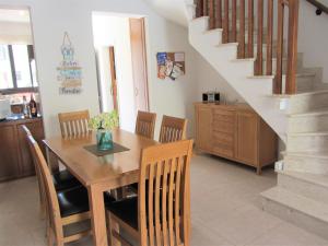 a dining room with a wooden table and chairs at Villa Jade in Paralimni