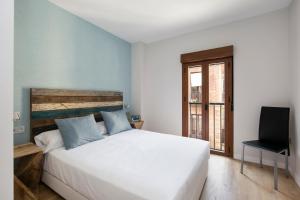 Łóżko lub łóżka w pokoju w obiekcie Cielo Granada