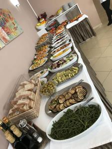a buffet with many plates of food on a table at Bikini Hotel in Vieste