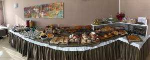 a buffet table with various types of bread and pastries at Bikini Hotel in Vieste