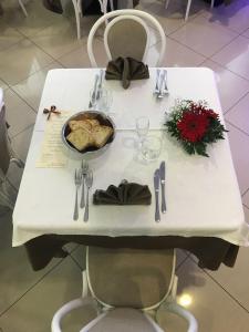 a white table with a plate of food on it at Bikini Hotel in Vieste
