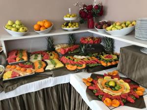 a bunch of fruits and vegetables on plates on a table at Bikini Hotel in Vieste