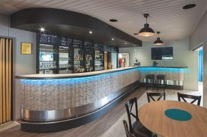a bar in a restaurant with tables and chairs at B&B Mierontie Oy in Konnevesi