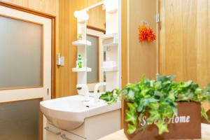 a bathroom with a sink and a potted plant at City Center House Next to Subway Station in Kyoto +50 photos