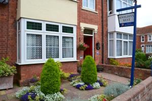 a brick house with a street sign in front of it at Knightsrest in Burnham on Sea
