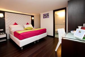 a bedroom with a large bed and a desk at Sorrento Flats in Sorrento