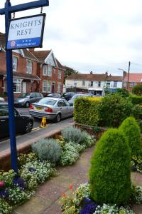 a street with cars parked in a parking lot at Knightsrest in Burnham on Sea