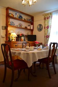 a dining room table with a table cloth on it at Knightsrest in Burnham on Sea