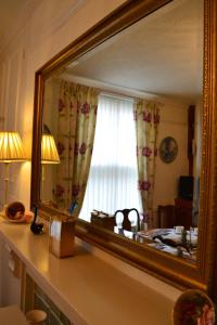 a mirror sitting on a counter in a room at Knightsrest in Burnham on Sea