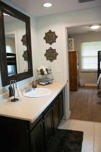 a bathroom with a sink and a mirror at Winter Park charm in Orlando