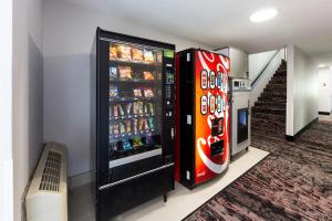 two soda machines are next to a staircase at Red Lion Inn & Suites Grants Pass in Grants Pass