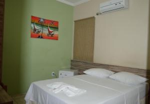 מיטה או מיטות בחדר ב-Pousada Ayrumã