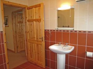 a bathroom with a sink and a mirror at Holiday Home Ardgroom-1 by Interhome in Ardgroom